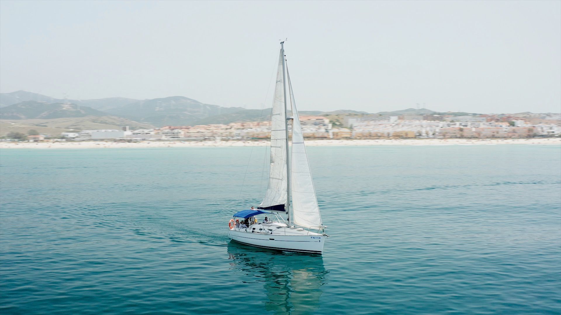 Vista aérea del velero a toda vela frente al paseo marítimo de Tarifa